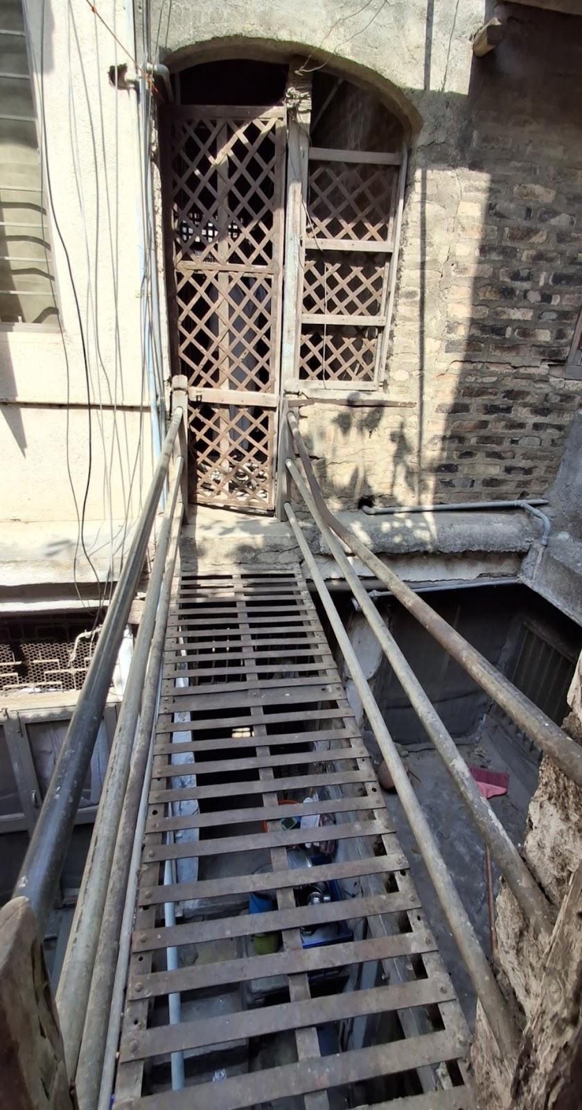 A simple metal bridge connecting areas on the first floor. (Source: CKA Archives)