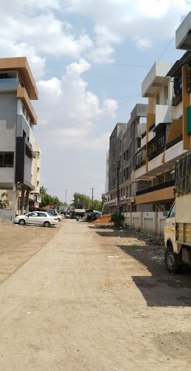 A street view of a developing urban area featuring several multi-storey buildings along an unpaved road. (Source: CKA Archives)