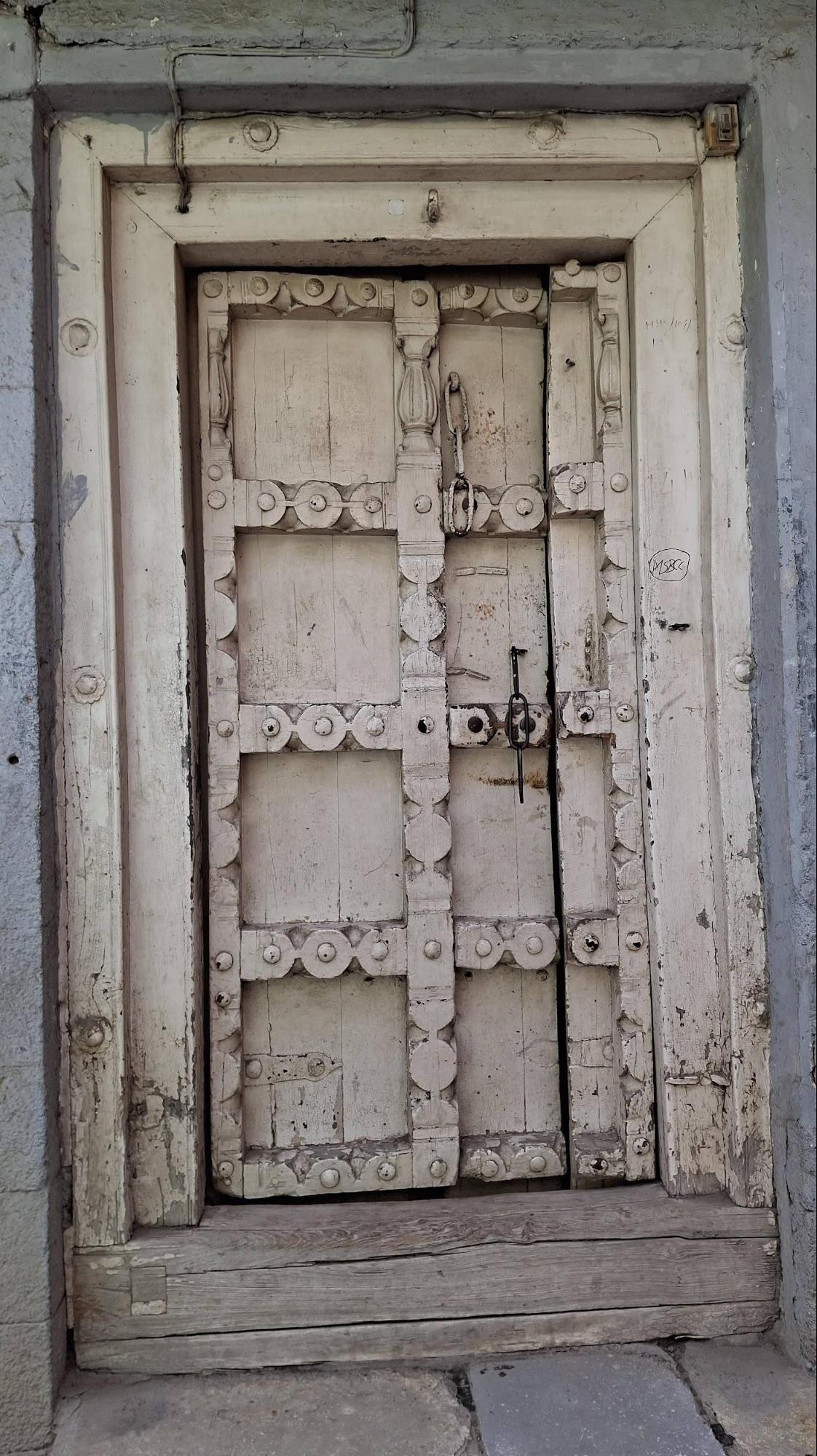 Different doors can be seen across the residential structure. The door at the entrance features a more decorative design with motifs. (Source: CKA Archives)