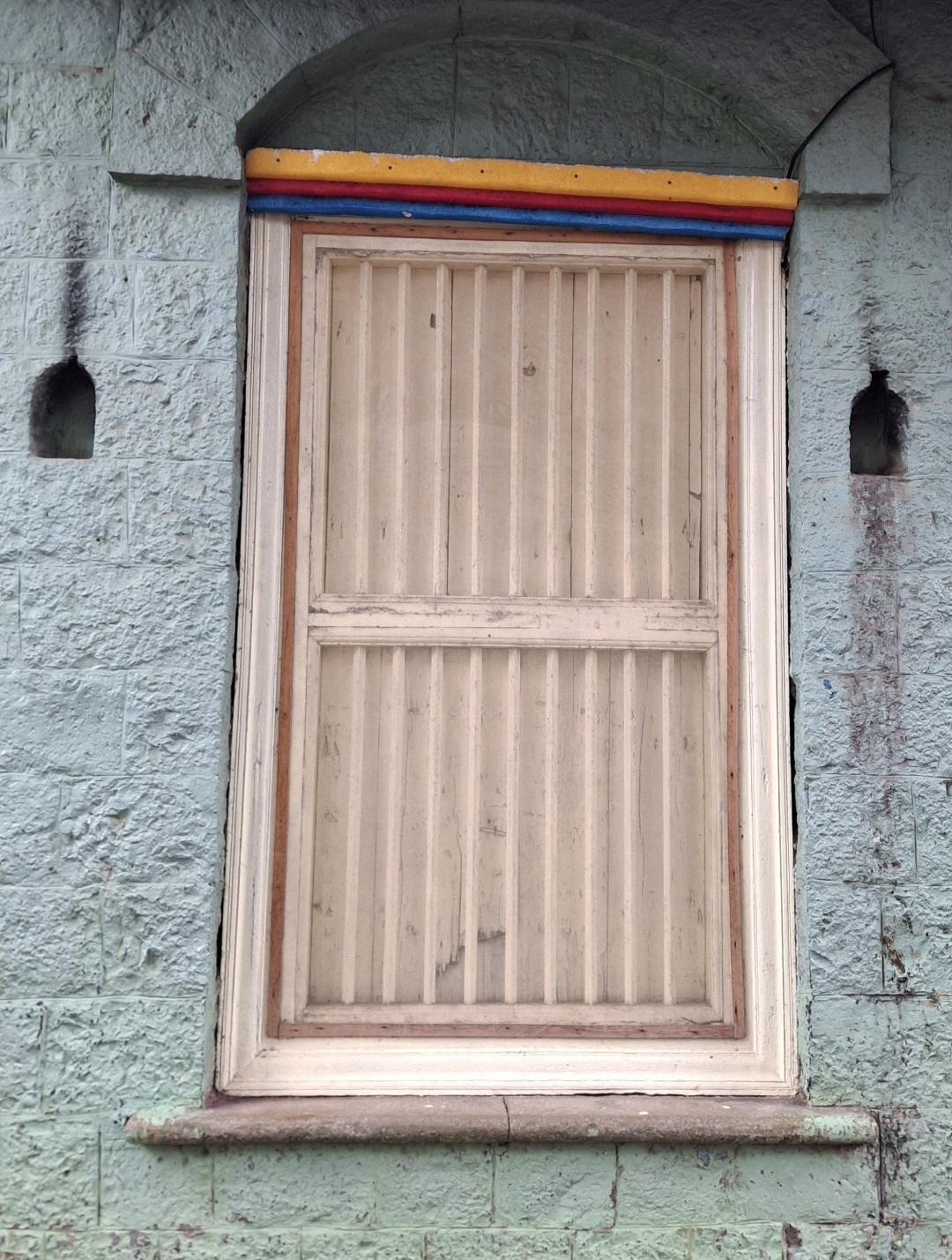 Front-facing windows framed by devlis for festival lighting, set within arched niches which have stone details. (Source: CKA Archives)