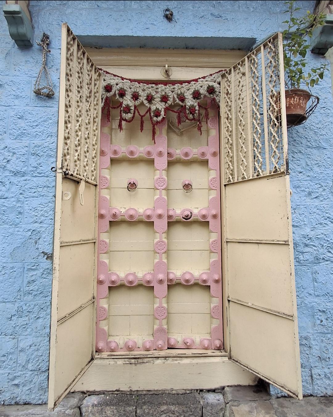 The main door displays decorative floral carvings with metal studs. (Source: CKA Archives)