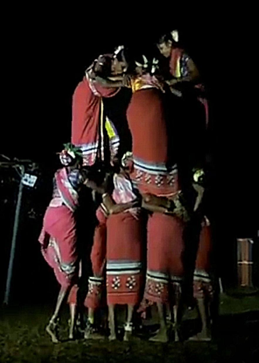 Women wearing red sarees and flowers in their hair form a unique formation during the dance. (Source: CKA Archives)