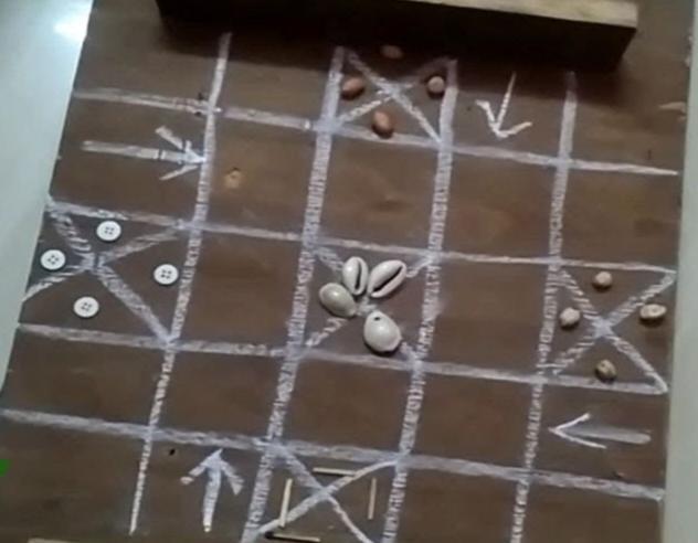 Champul is a strategic board game for two to four players where the goal is to race coins to the center of a 5x5 board. Players roll four cowrie shells to determine movement, blending chance and strategy as they choose which of their four coins to move. While historically popular as Champulyain rural areas, it has been largely replaced by Ludo (Source: CKA Archives).