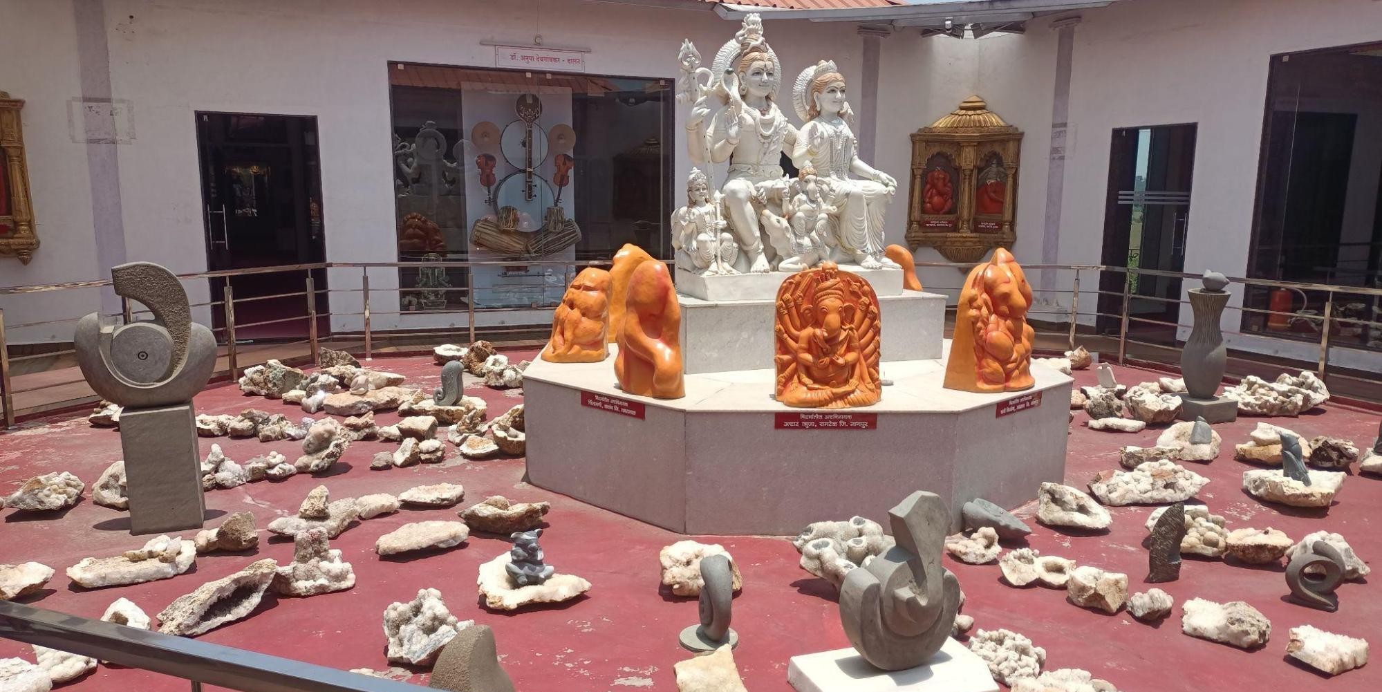 Central exhibit at the Nanda Udyan Ganpati Museum, Amravati featuring a marble sculpture of Lord Shiva, Parvati, and Ganesha, surrounded by a diverse collection of carvings and depictions of Ganesh. (Source: CKA Archives)