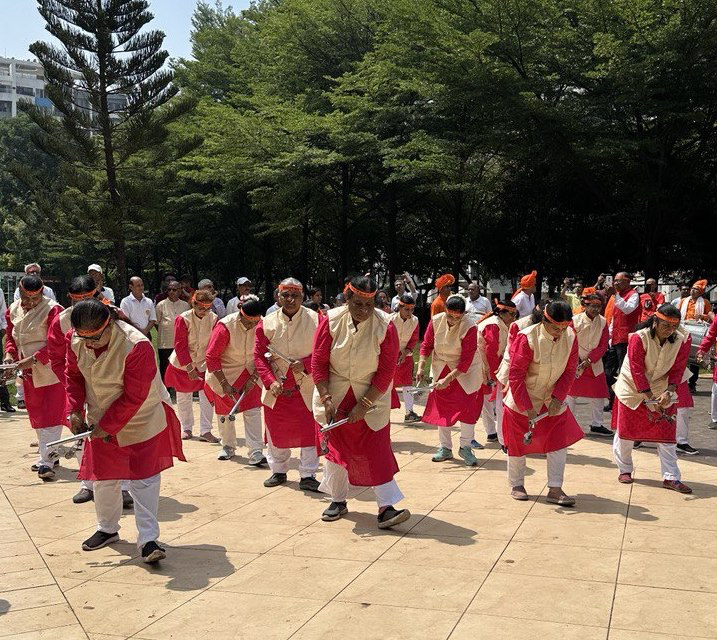 The performance typically involves a group of dancers, often men, who execute various movements such as stepping, hopping, and squatting in synchrony. The dance can be quite vigorous and is frequently used as a fitness drill in schools across Maharashtra.[1]