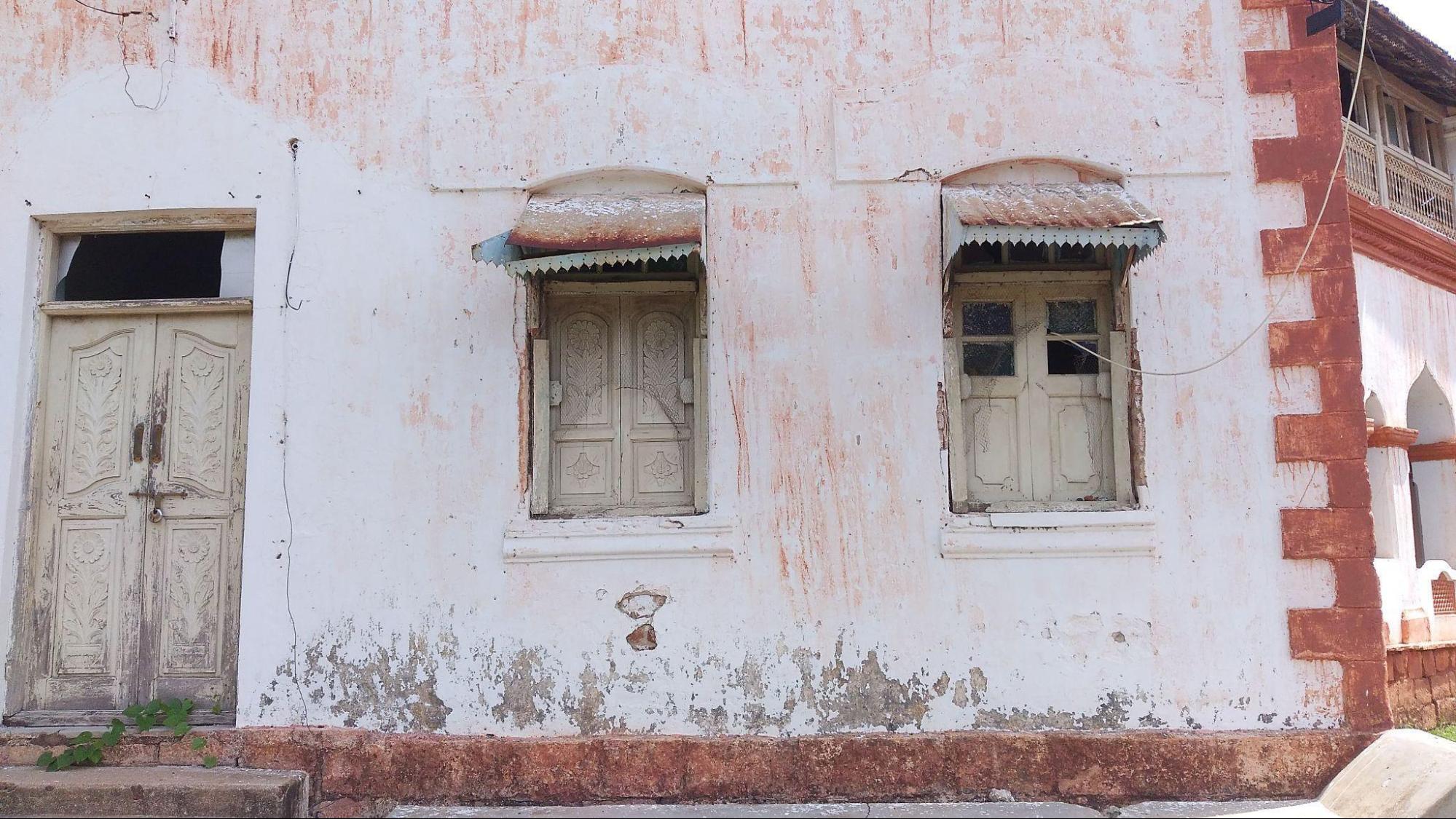 Exterior window with ornate carvings and decorative trim work above. (Source: CKA Archives)