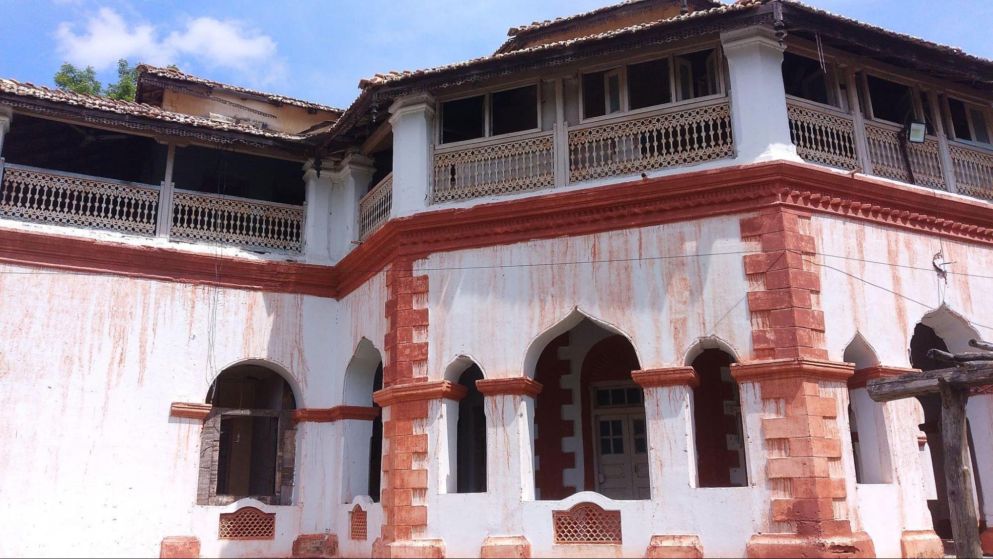 The upper storey features a covered terrace, enclosed by carved wooden railings and shaded by the extended roof. Unlike a projecting balcony, this space is more integrated into the building, serving as a semi-open extension of the interiors. (Source: CKA Archives)
