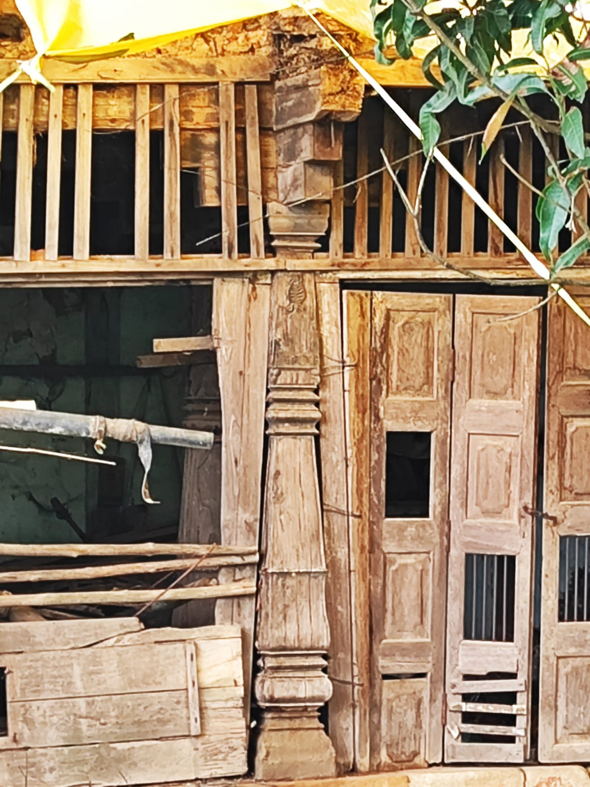 A multilevel wooden paneled door at the Wada. Notice the vertical wooden supports and horizontal railings. The exposed structural elements reveal the timber frame construction methodology used throughout the wada. (Source: CKA Archives)