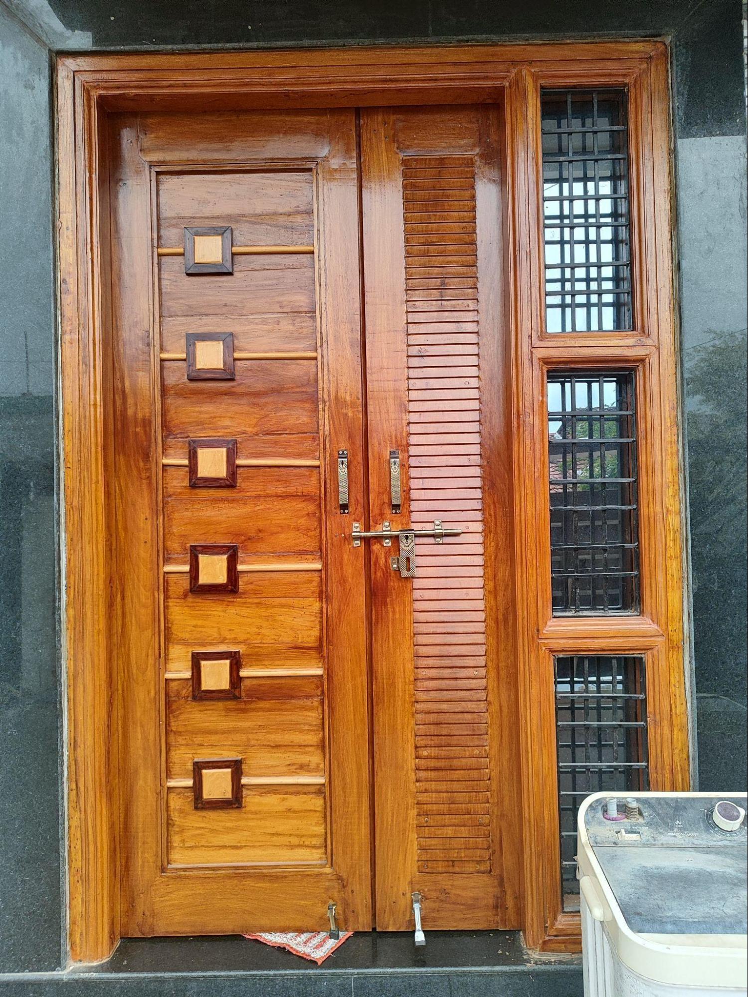 The wooden entrance door with glass panels which adds to both its functionality and design appeal. (Source: CKA Archives)