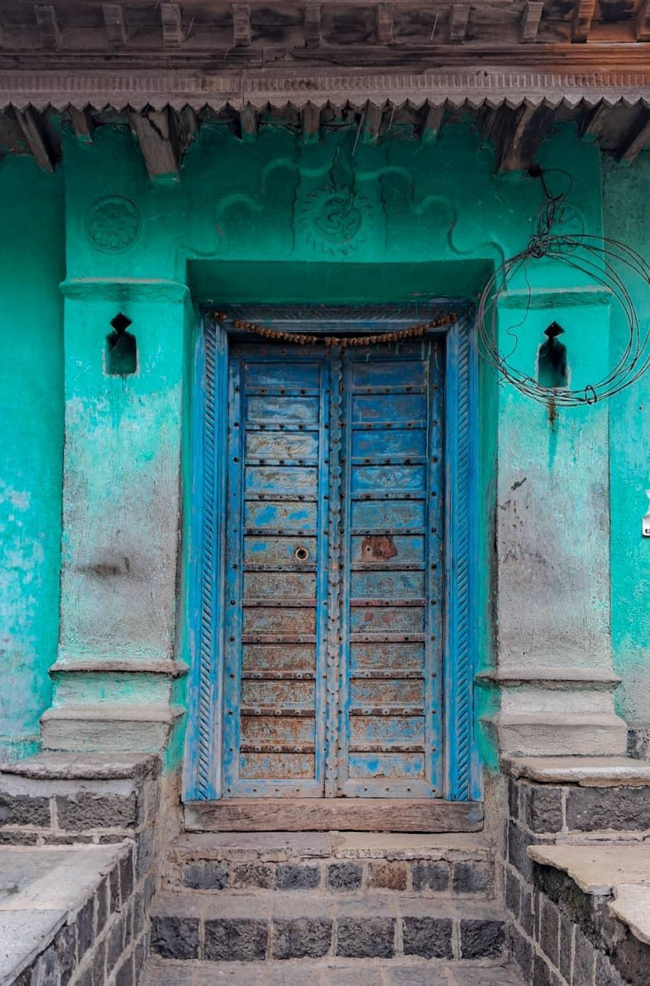 The blue door that stands at the entrance of the house. (Source: CKA Archives)