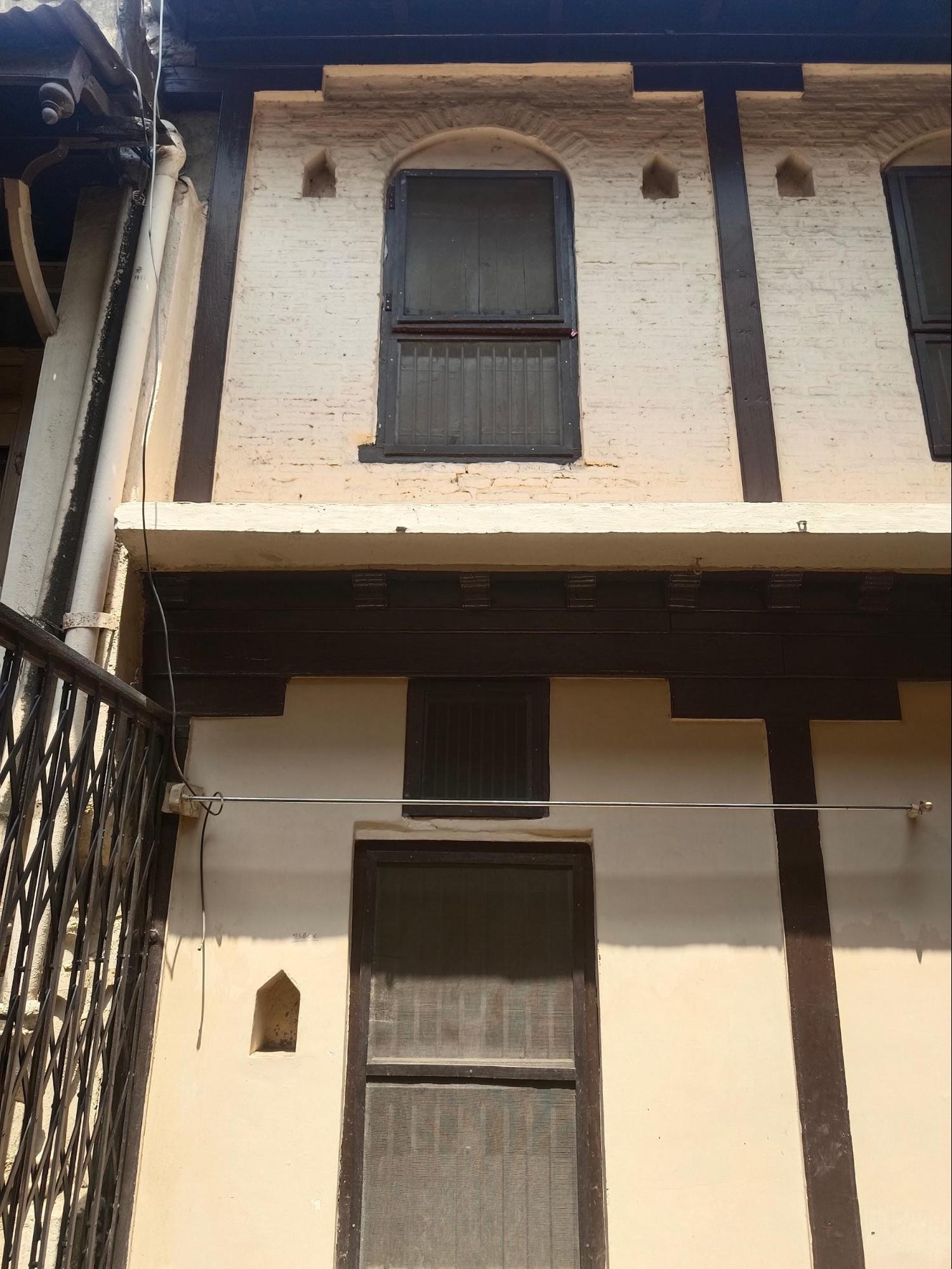 An exterior view of the Wada’s windows, highlighting their proportional arrangement and the contrast between the ground and upper storey designs. The use of wooden trims and security grills here highlights the ways both functional and aesthetic considerations were incorporated into the building traditions of the time. (Source: CKA Archives)
