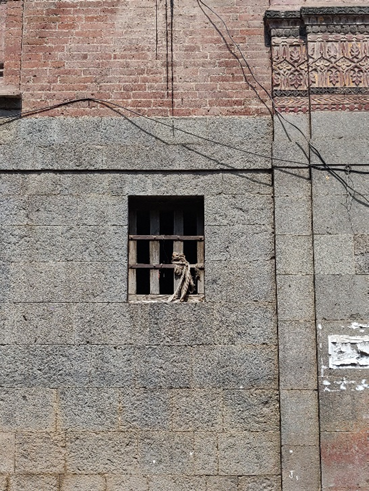 Ground floor window with metal grill protection demonstrating practical security considerations. (Source: CKA Archives)