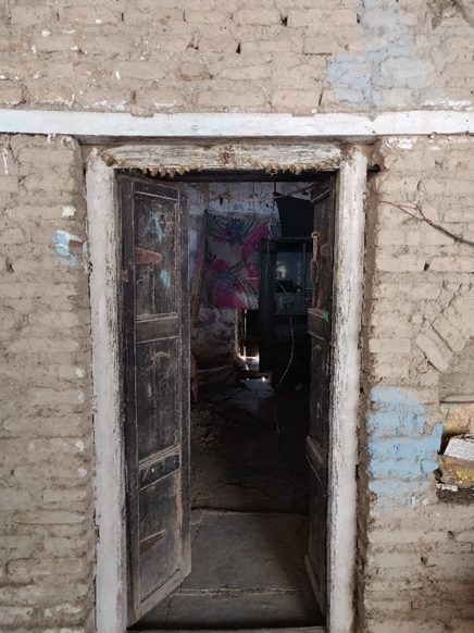 Interior perspective showing a wooden double door with traditional design elements within the house. (Source: CKA Archives)