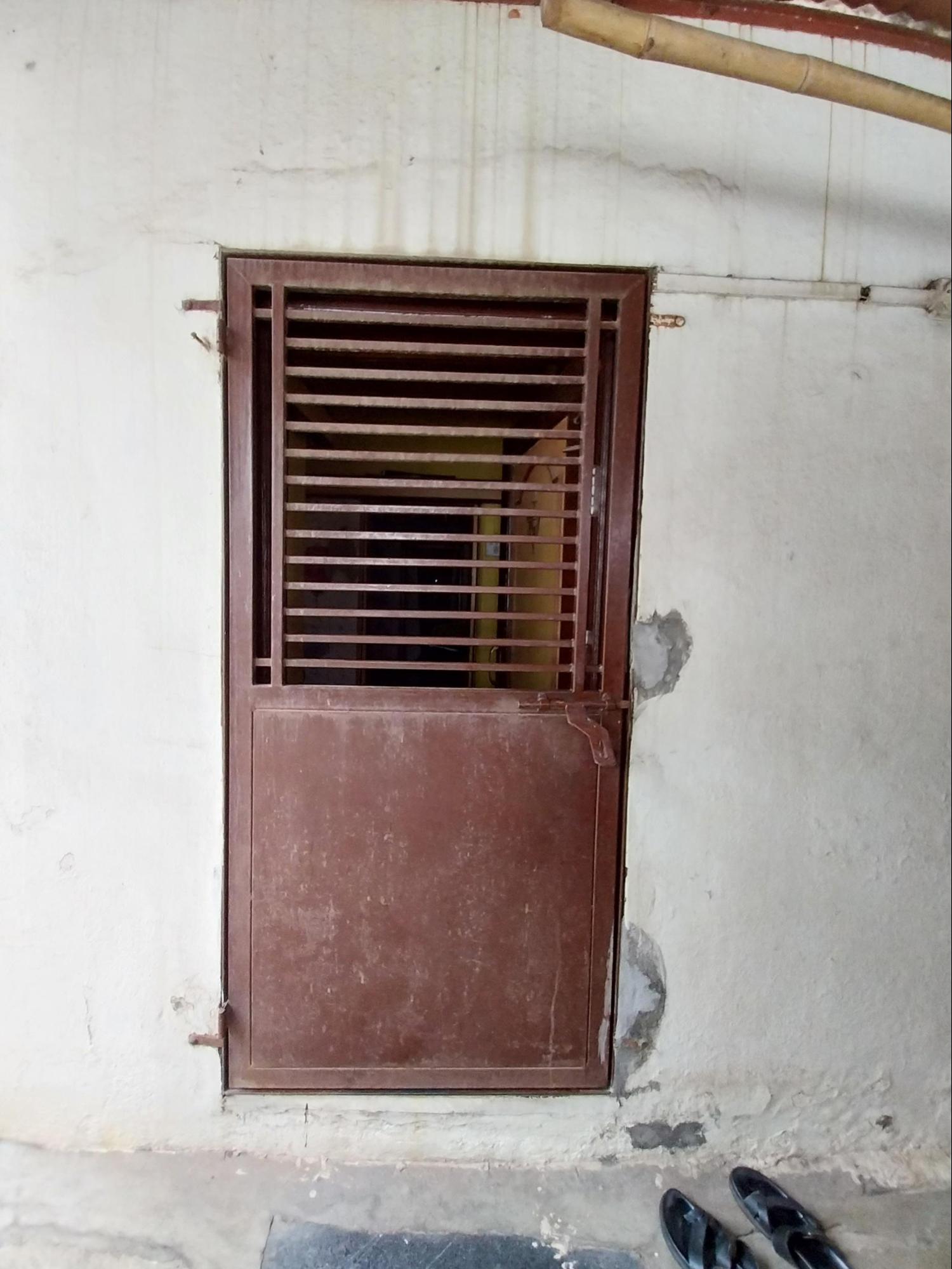 A functional iron door adjacent to the kitchen provides access to utility spaces, demonstrating the practical material choices made for service-oriented areas of the home. (Source: CKA Archives)