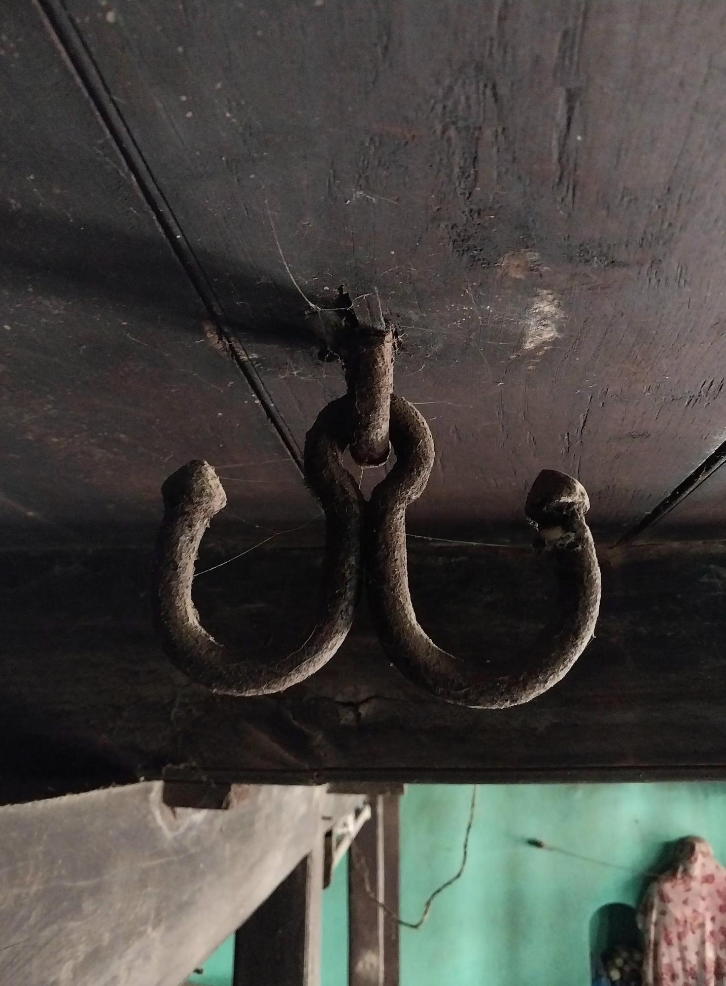 A vintage lampshade hanging from the ceiling, showcasing traditional lighting solutions used before electricity became commonplace. (Source: CKA Archives)