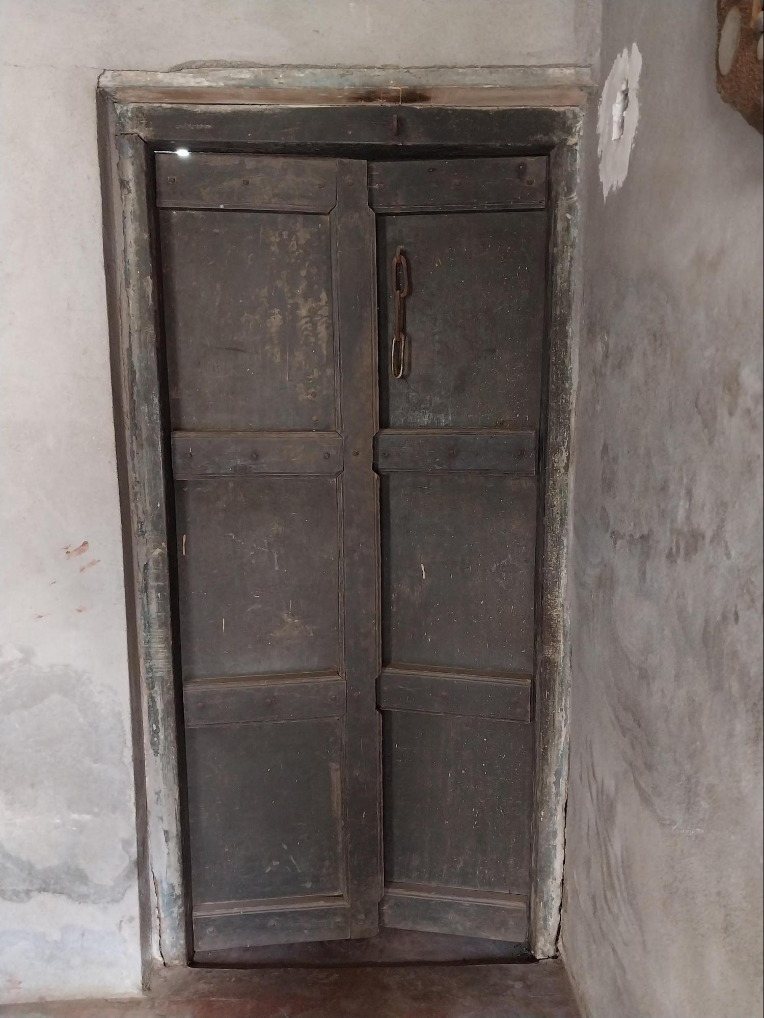 An old wooden door has been kept in the storeroom, offering a glimpse of the home's original features. (Source: CKA Archives)