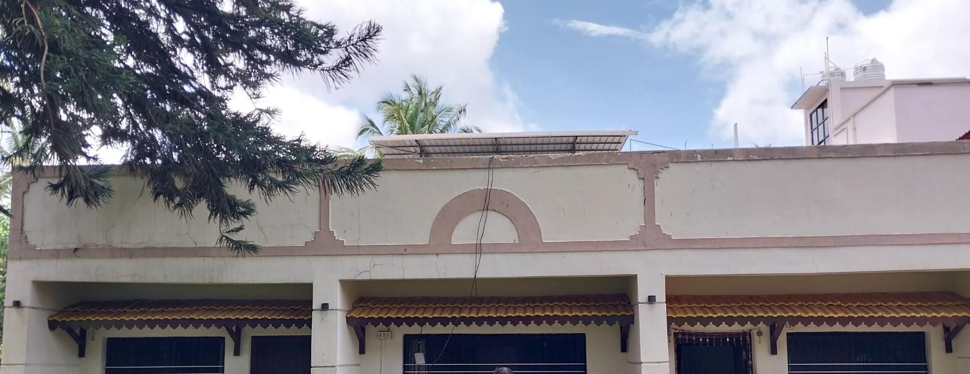 The parapet wall with a decorative central arch, partially finished in a soft peach hue. Its decorative design features a central arch, adding symmetry and visual appeal to the building’s facade. (Source: CKA Archives)
