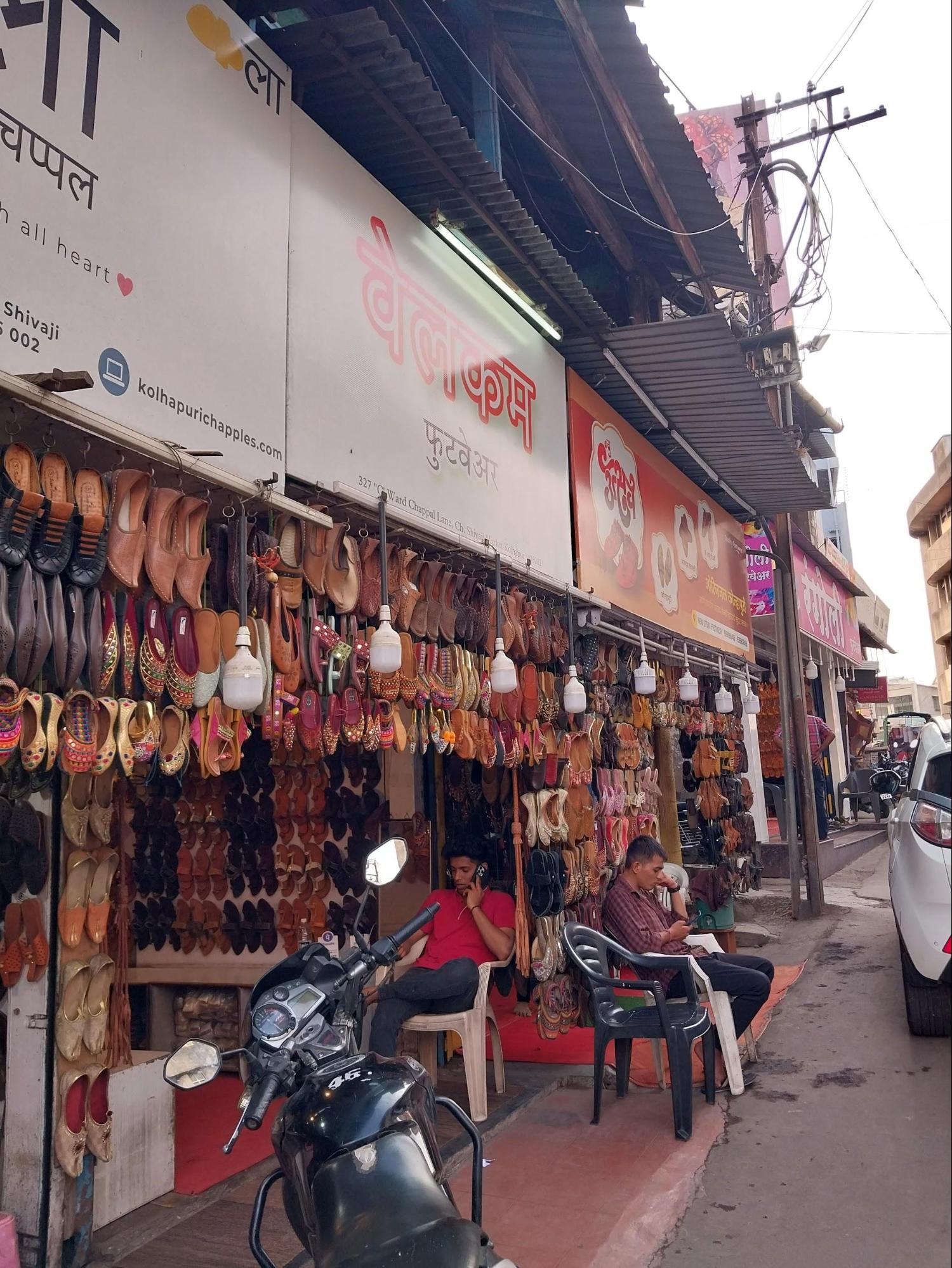 Kolhapur’s Chappal Galli is famous for handcrafted leather Kolhapuri Chappals, known for their durability, style, and heritage. Made from buffalo hides, these sandals range from ₹150 to over ₹10,000, with styles like Kapshi, Amdaar, and Shahu. Some designs include “vinchu” seeds that produce a distinct sound. The craft dates back to the 12th century and remains a key attraction for tourists and locals alike (Source: CKA Archives).