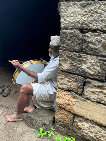 Seated quietly in Latur, a dhol player rests with his instrument. (Source: CKA Archives)