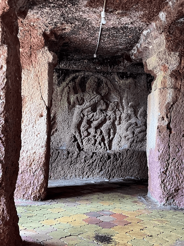 Interior of one of the Kharosa Caves. The walls are carved with narrative panels depicting devis and devtas and scenes from religious texts, including Shiva and Parvati. (Source: CKA Archives)
