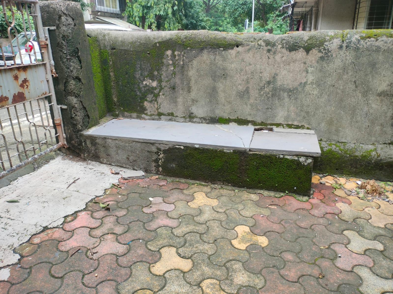 A concrete and granite bench stands near the gate, offering a small resting space. A fixed bench near the entrance is used by residents for casual seating.(Source: CKA Archives)