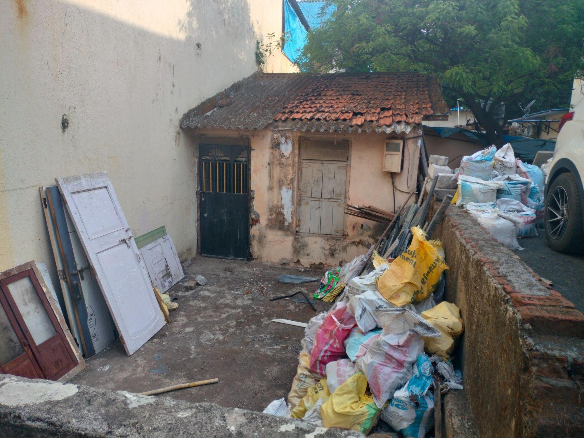 An exterior view of the original wooden windows with double shutters, featuring upper ventilation slots at a downtrodden block house at Mulund Colony. (Source: CKA Archives)