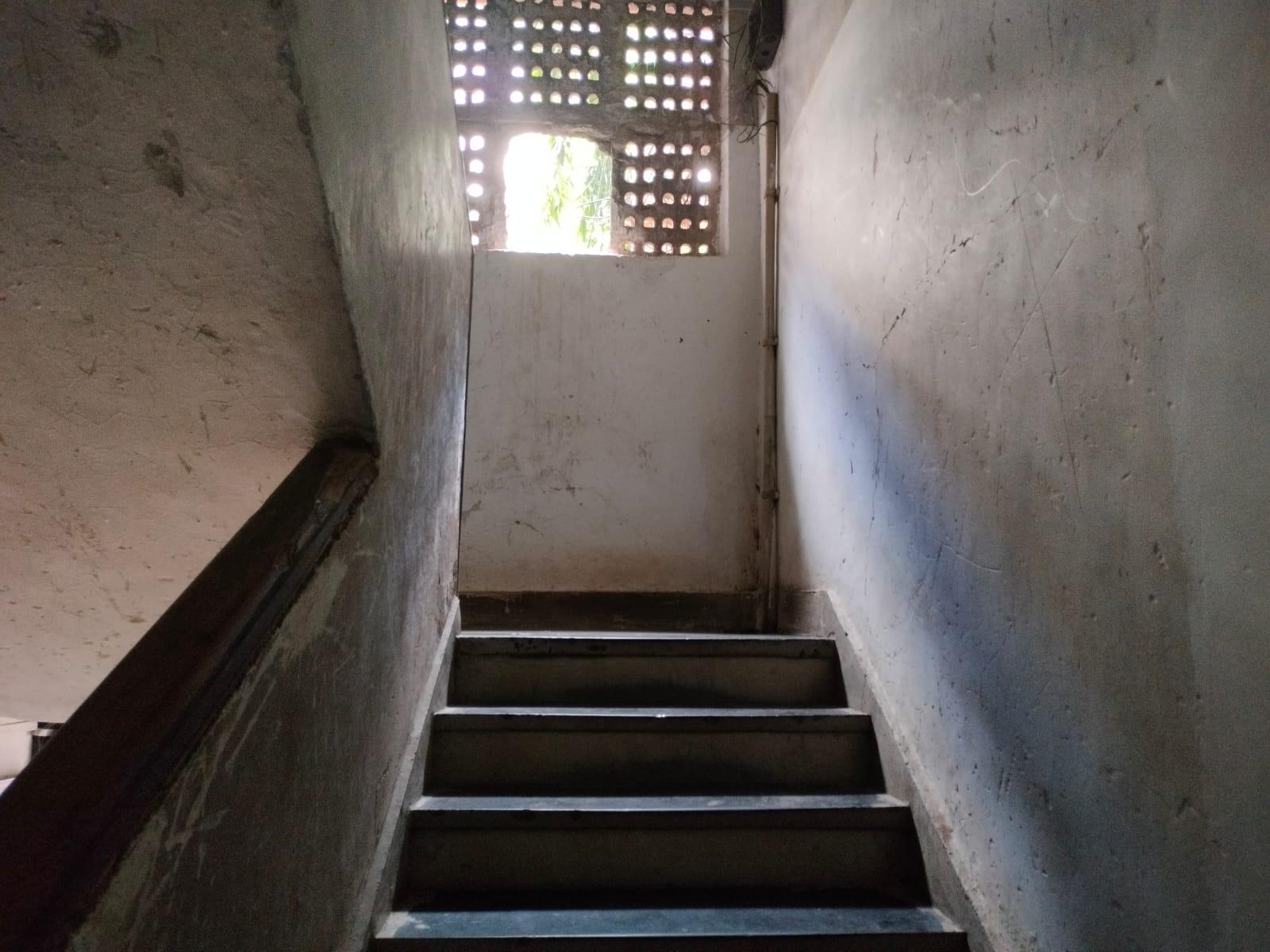 Staircases are bordered by a wall with patterned openings that allow for light and airflow. (Source: CKA Archives)