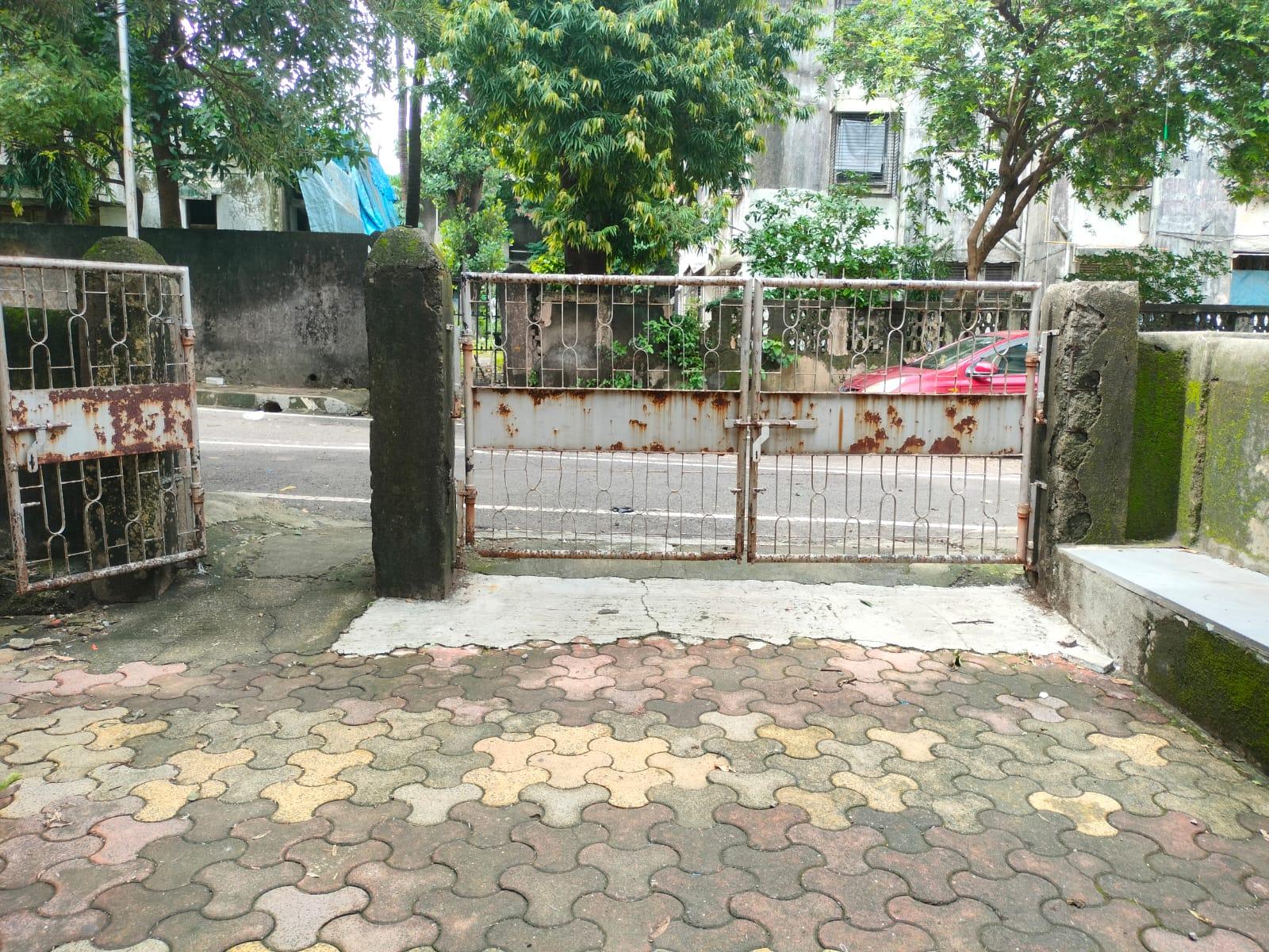 The main entrance has separate pedestrian and vehicle gates, both designed with simple geometric patterns. (Source: CKA Archives)