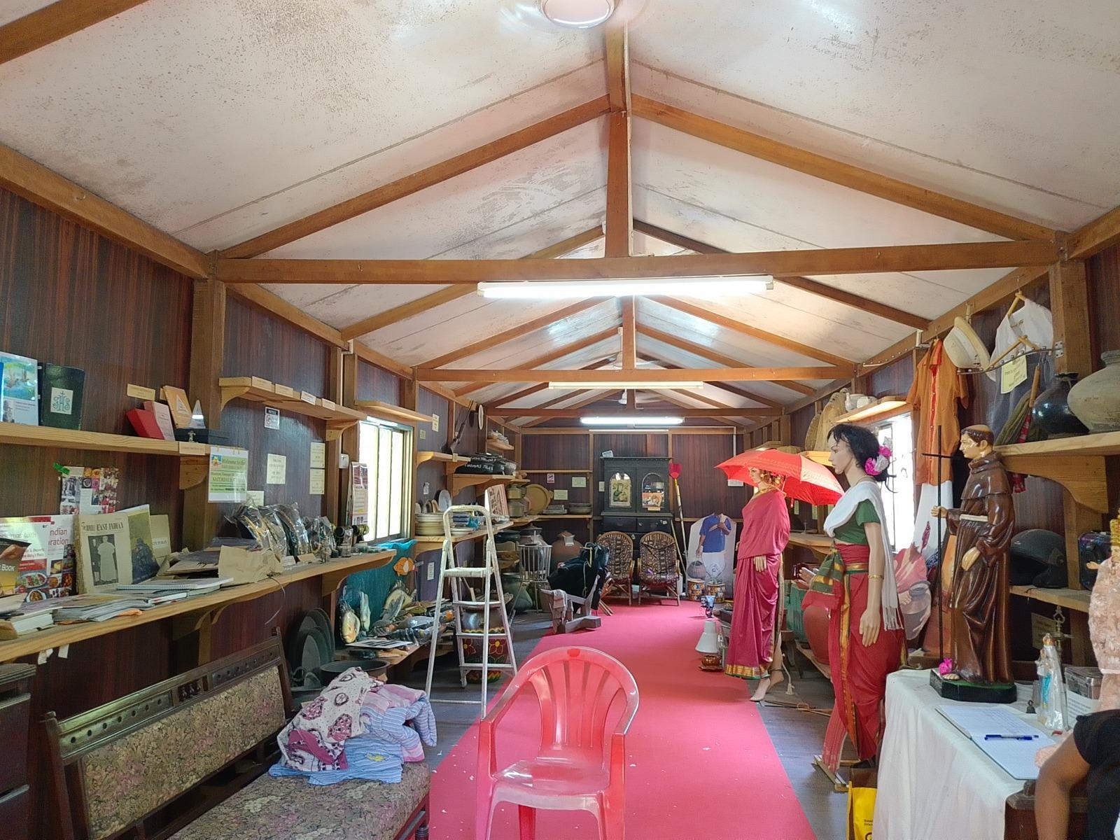 Community-contributed items from East Indian homes, including embroidered garments and cooking vessels. (Source: CKA Archives)