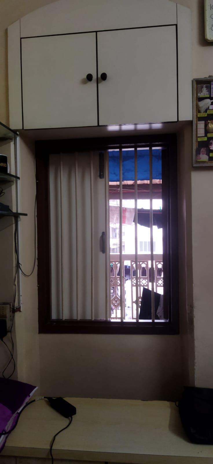 Renovated windows with aluminum sliding frames and an overhead storage cabinet. Source: CKA Archives