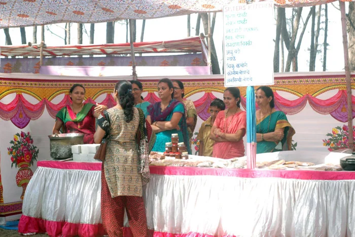 A stall displays a variety of chikoo-based products, highlighting the area's agricultural innovation.[1]