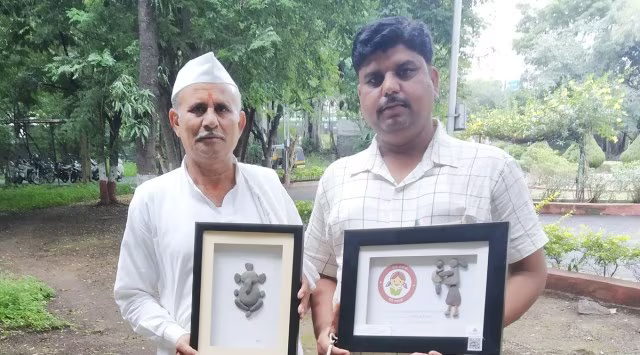 Artist Prahlad Pawar with his father, displaying pebble artworks featuring a Beti Bachao message and an image of Ganpati, created using pebbles and stones from the Godavari River.[3]