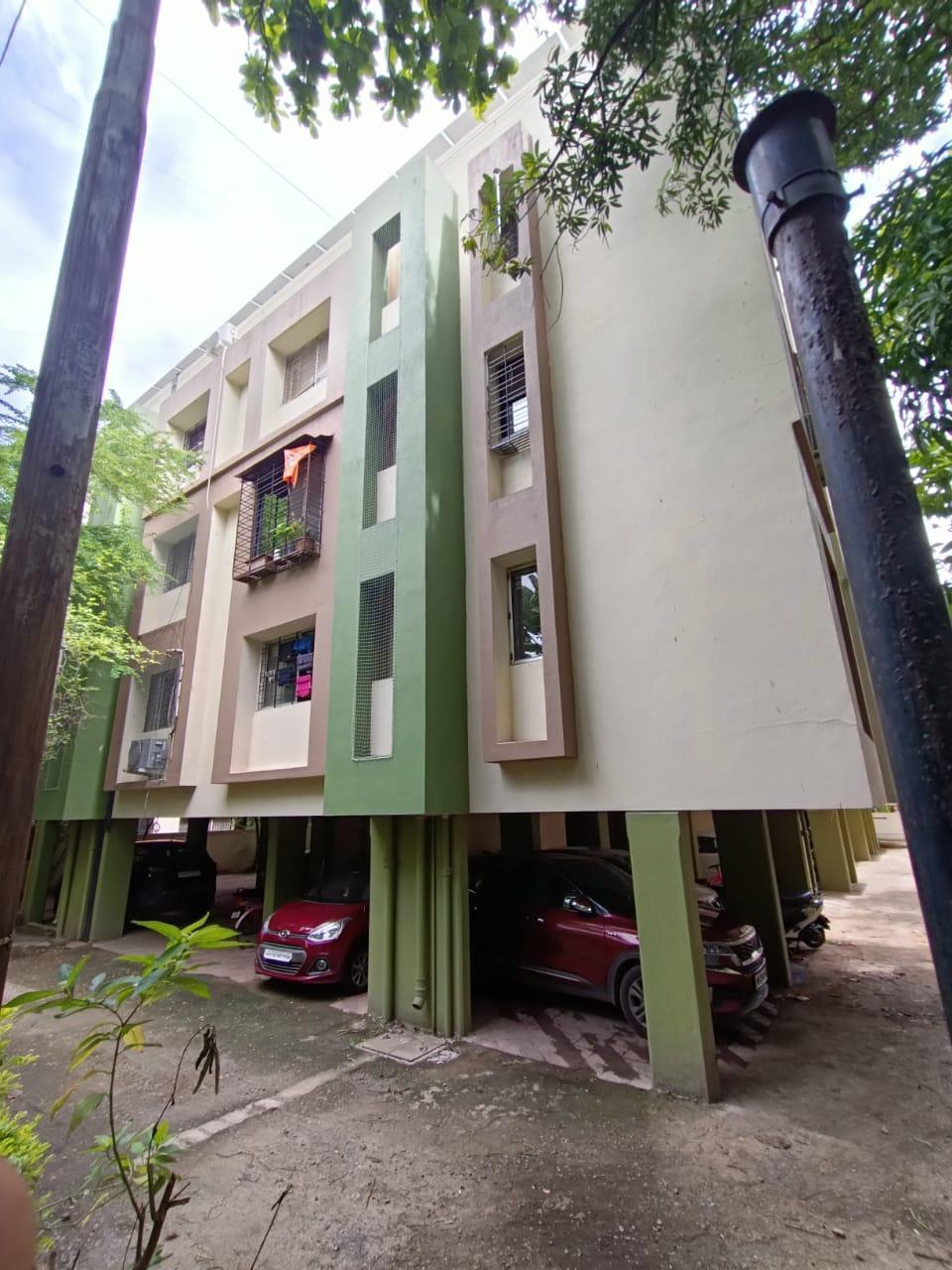 A closer view of the residential building which has an interesting modular color panel design. The building appears to use contrasting rectangular sections of white, dark green and light brown. (Source: CKA Archives)