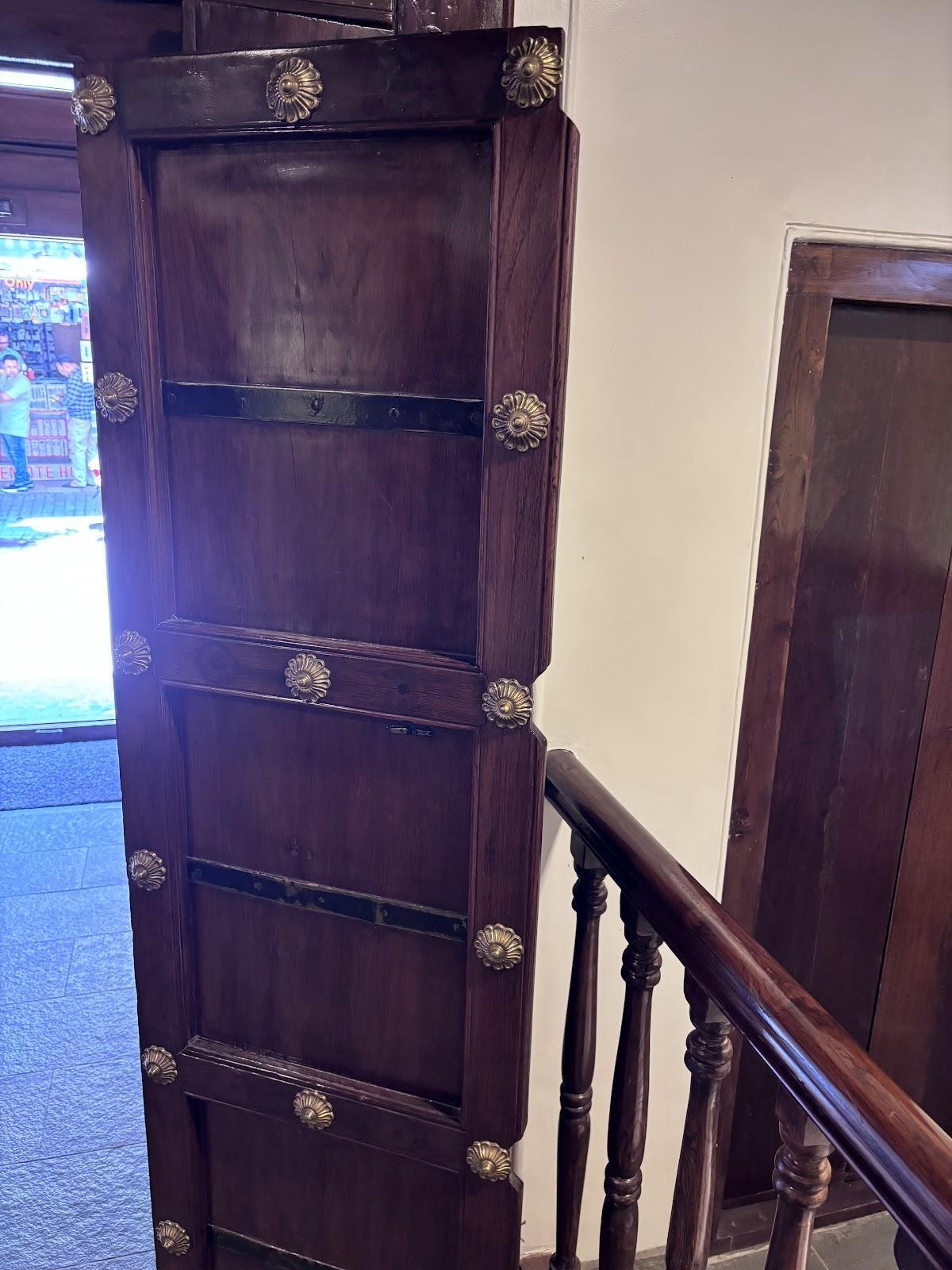 A deep-brown wooden door with golden embellishments at the main entrance of the wada. (Source: CKA Archives)