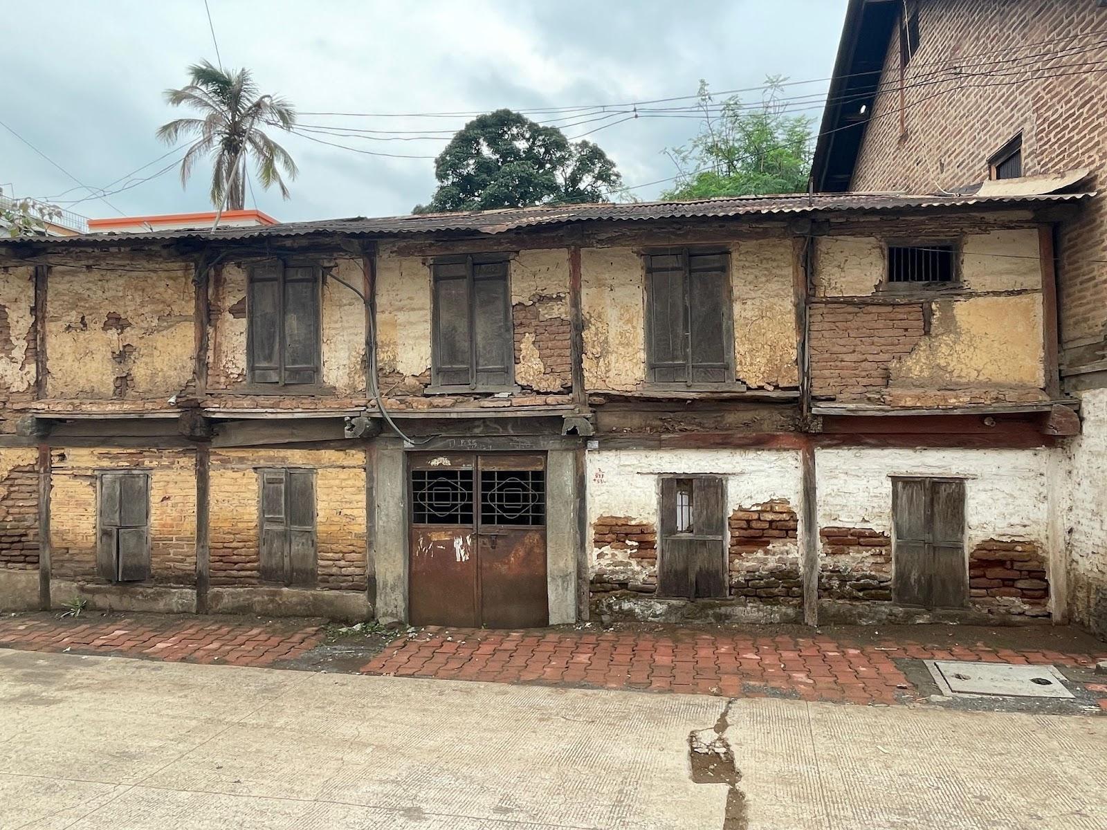 An old residential building featuring double-shuttered windows and a door, estimated to be built in the 1860s, with brick making up its composite structure. (Source: CKA Archives)