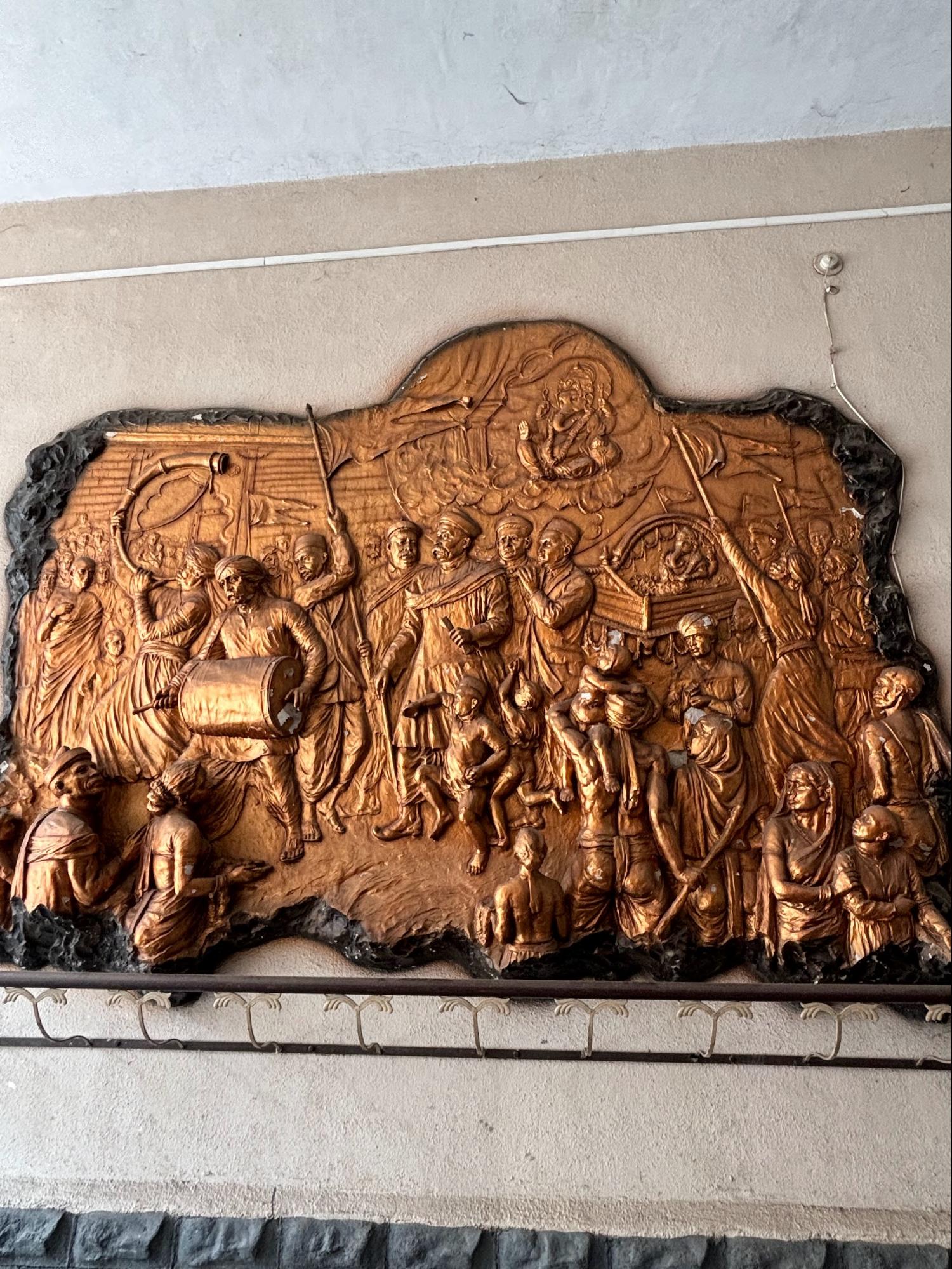 A tile plaque near the entrance displays Tilak leading Ganpati celebrations in Pune with passionate drumming beats and onlookers getting energised by this celebration. (Source: CKA Archives)
