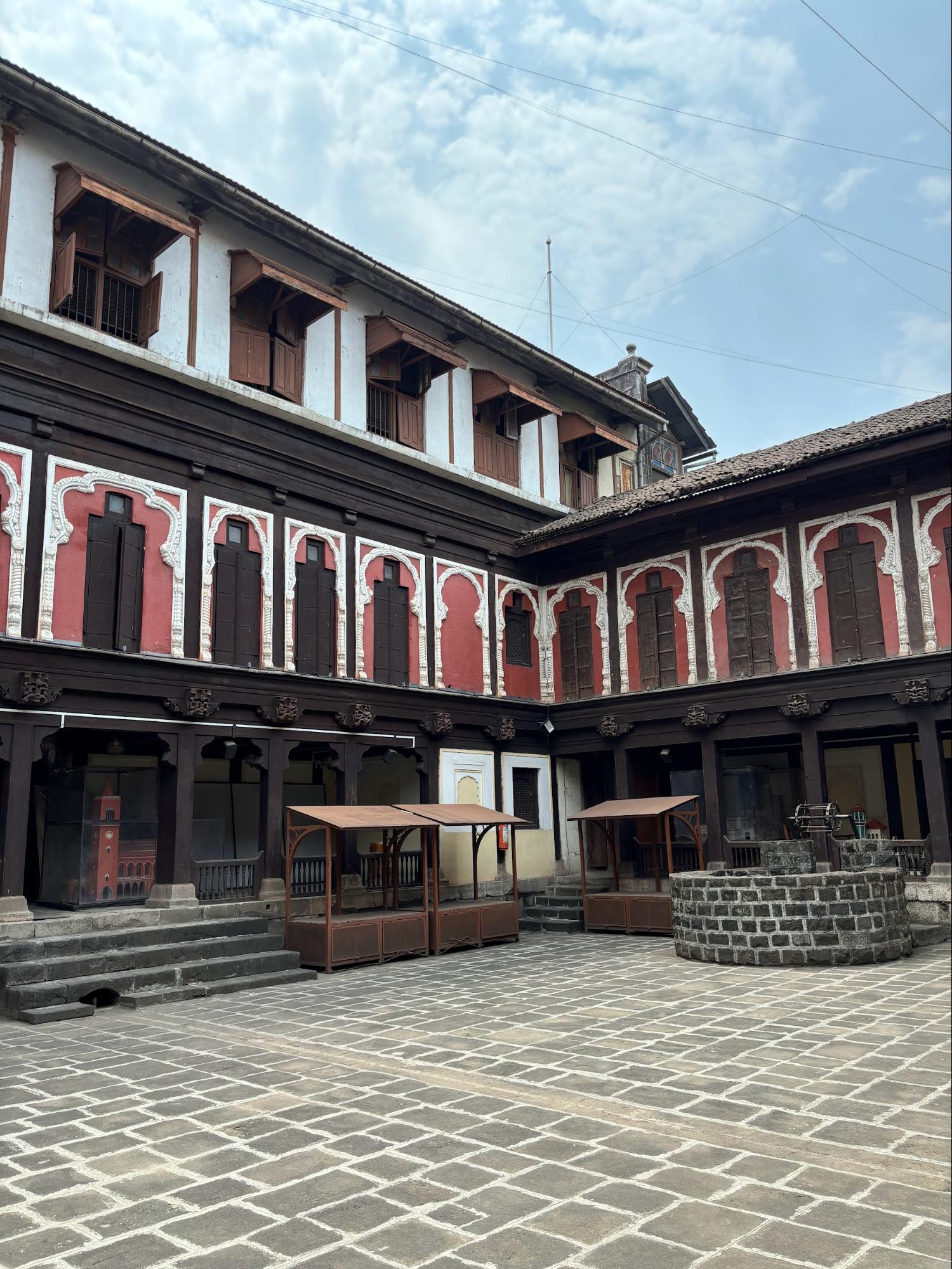 The central courtyard of Vishrambaug Wada, surrounded by wooden balconies and carved pillars. Such courtyards were central to social and domestic activities in Maratha-era mansions. (Source: CKA Archives)