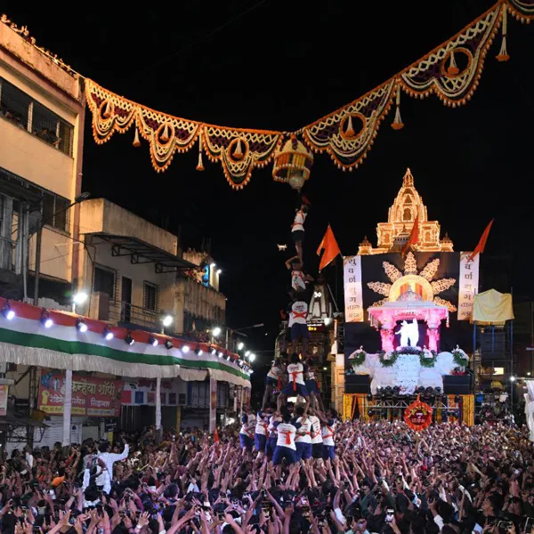 A lively Govinda pathak forms a human pyramid beneath the handi during the Dahi Handi celebration at Dagdusheth Halwai Ganpati in Ganpati Chowk.[1]