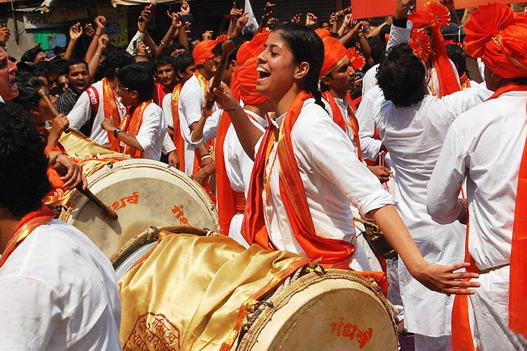 Members of a dhol-tasha pathak, filling the city with rhythmic beats.[2]