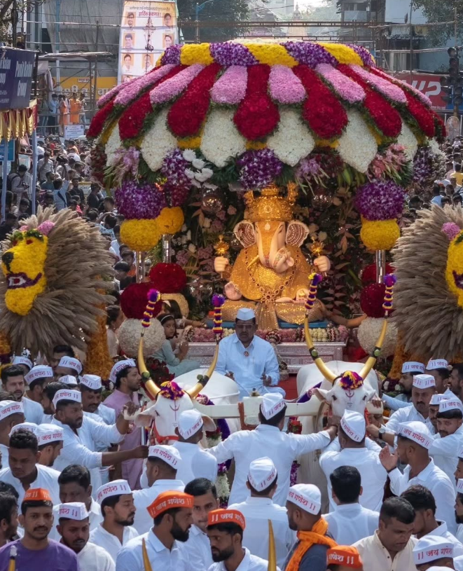 The richly adorned murti of Dagdusheth Halwai Ganpati is taken through Pune’s streets during visarjan, drawing thousands of devotees and onlookers.[5]