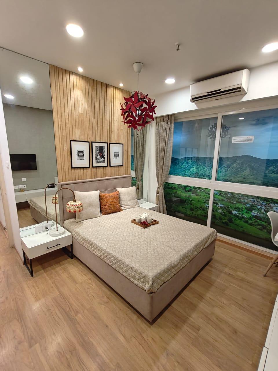 Bedroom with a large aluminum-framed window and wooden flooring. (Source: CKA Archives)