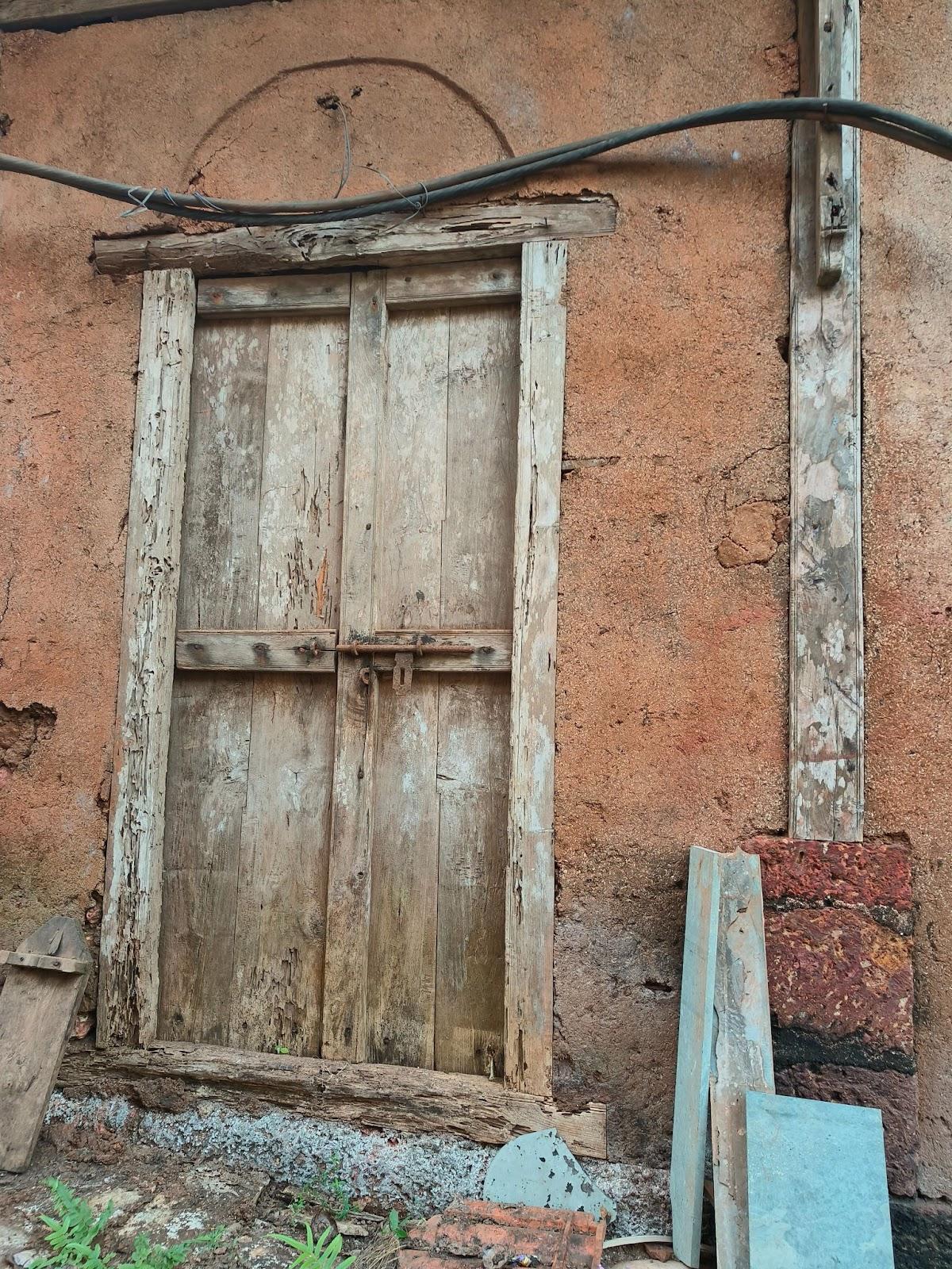 Wooden double-shuttered door with an iron latch. (Source: CKA Archives)