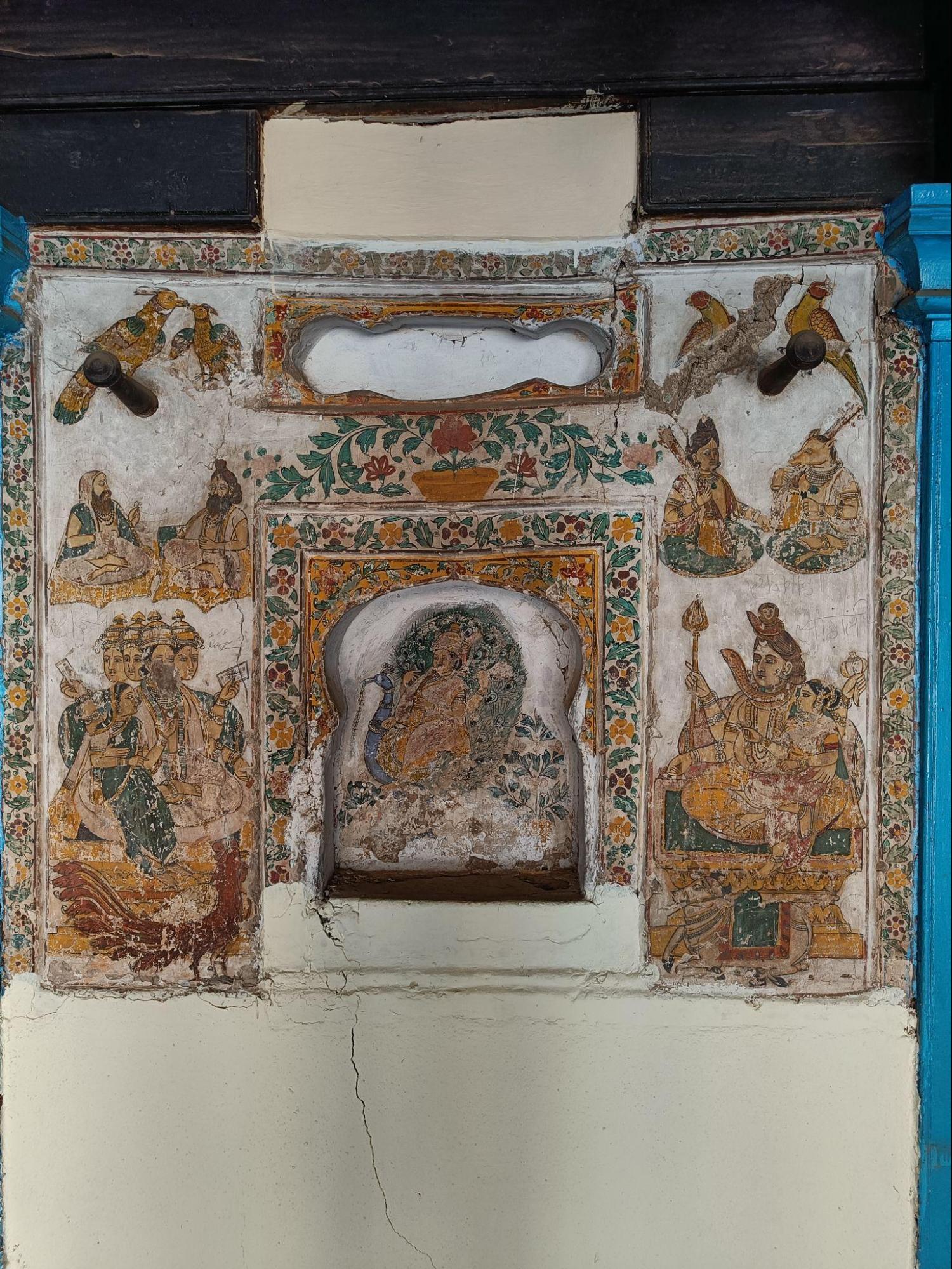 The walls of the Rajwada are adorned with beautiful paintings and drawings. In frame is a drawing of Nandi alongside the pair of Bhagwan Shiv and Devi Parvati, Kartik aboard his vahan- peacock, rishis, and parrots. (Source: CKA Archives)