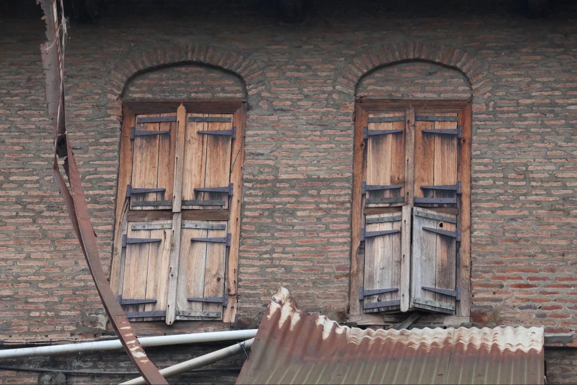 Arched brick-framed windows with timber shutters on the front façade. The repetition of form and proportion contributes to the overall symmetry of the building. (Source: CKA Archives)