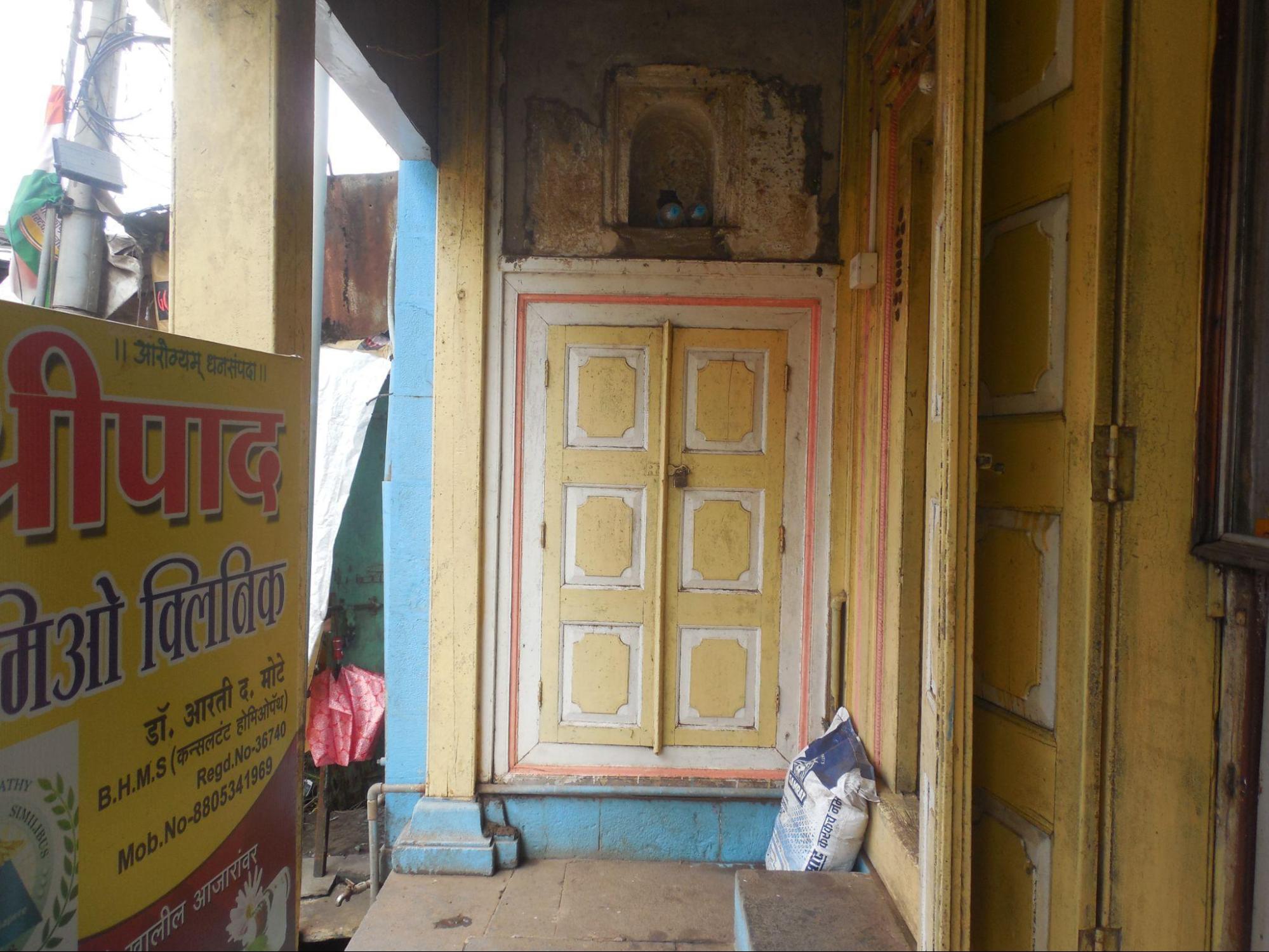 The door features a pale yellow and white color palette, accented by an orange border. (Source: CKA Archives)