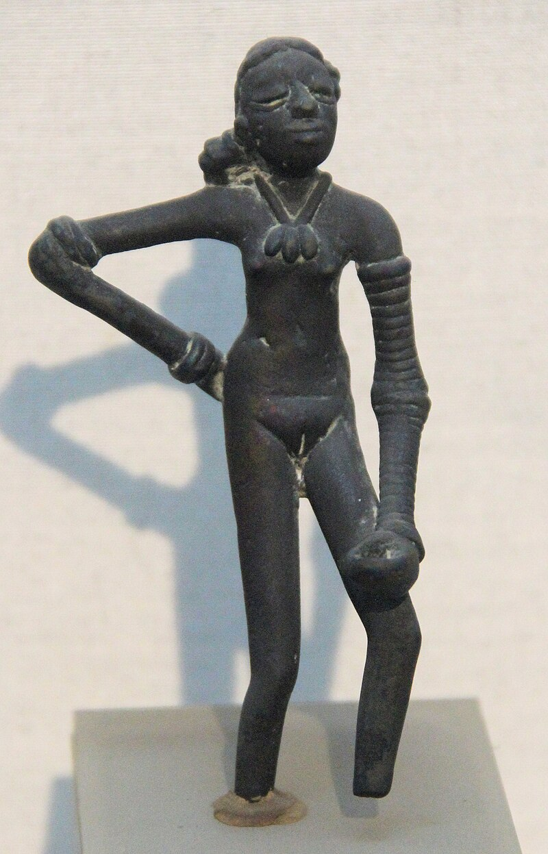 The Dancing Girl of Mohenjodaro, a figurine from around 2500 BCE, often cited as an early example of metal casting techniques similar to Dhokra.[3]