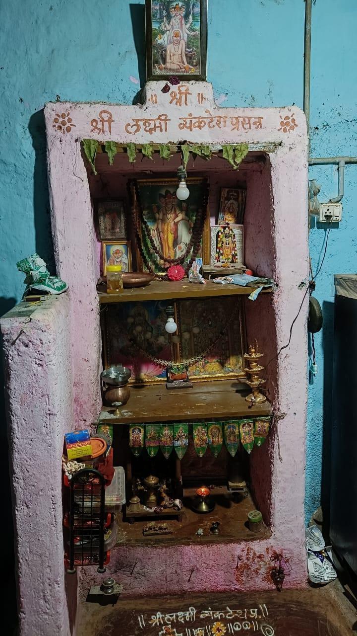 Devghar holding paintings of different devtas. The residents seem to primarily worship Datta Bhagwan, also known as Trimurti. Notice the traditional rangoli drawn at the bottom. The Devghar also features written Shlokas worshipping Devi Lakshmi - a Devi primarily associated with prosperity. (Source: CKA Archives)