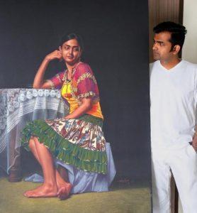 Shashikant Dhotre standing beside one of his portraits.[6]