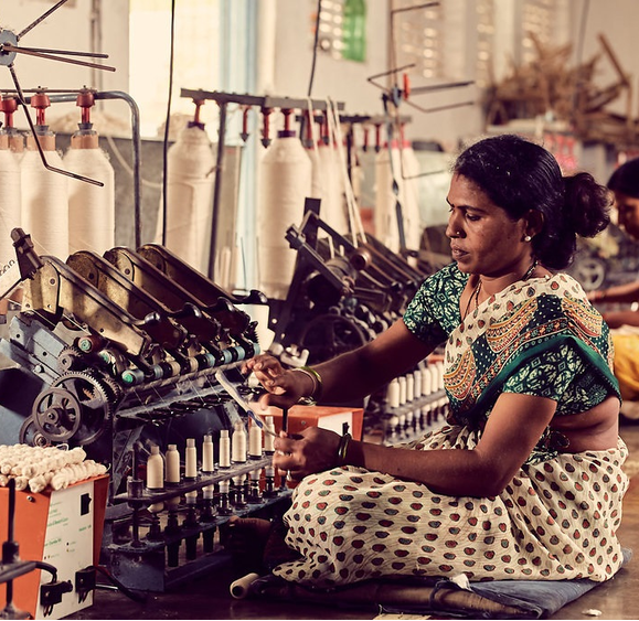 A woman working on fabric at the production facility of Magan Khadi, Wardha.[2]