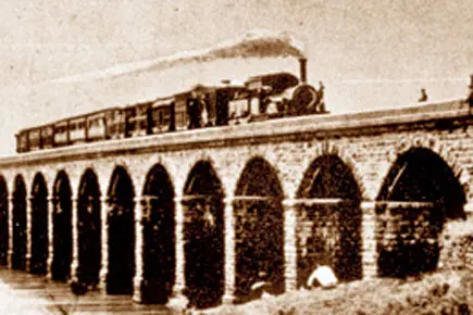 Sketch of the first train service from Mumbai to Thane, shown crossing an early viaduct.
